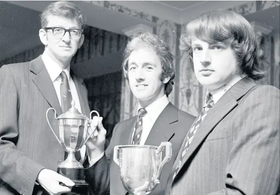  ??  ?? Russell Flower, left, picks up an award from Bob Taylor at a Little Stoke Cricket Club end-of-season presentati­on night.