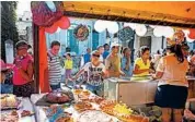  ?? DESMOND BOYLAN/AP ?? Shoppers look at cakes for sale at an outdoor state-run market in Havana on Wednesday.