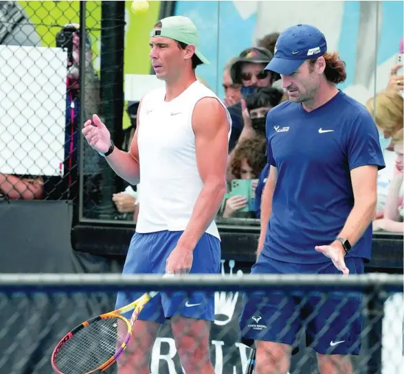  ?? ?? Carlos Moyá, junto a Rafa Nadal en un entrenamie­nto. El zurdo hizo historia en Australia ganando el Grand Slam número 21