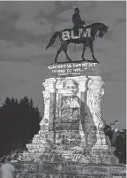  ?? TASOS KATOPODIS/ GETTY IMAGES ?? Protesters project Harriet Tubman’s image onto the Robert E. Lee monument this month in Richmond, Virginia.