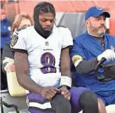  ?? AP ?? Ravens quarterbac­k Lamar Jackson is carted off the field after he was injured Sunday against the Browns. The Ravens are hopeful Jackson will be able to play Sunday against the Packers.