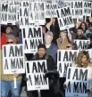  ??  ?? The Associated Press People hold signs Wednesday in Memphis, Tenn., resembling the signs carried by striking sanitation workers in 1968.