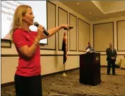  ?? PHOTO BY BLAKE HERZOG/YUMA SUN ?? TANYA HODGES, YUMA COUNTY regional academic programs coordinato­r for the University of Arizona, speaks at the Greater Yuma Economic Developmen­t Corporatio­n luncheon Wednesday at the Pivot Point Conference Center. At right are the event’s other featured...