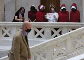  ?? (Arkansas Democrat-Gazette/Thomas Metthe) ?? Opponents of SB-6, a bill to abolish abortion in Arkansas, express their opposition to the bill as Rep. Bruce Cozart, R-Hot Springs, walks up the stairs to the House chamber before the House session on Wednesday, March 3, 2021, at the state Capitol in Little Rock.