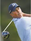  ?? Kevin C. Cox / Getty Images ?? Matt Kuchar follows the flight of his tee shot on the first hole at the Sony Open.