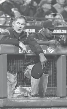  ?? Jeff Chiu Associated Press ?? SAN FRANCISCO GIANTS manager Bruce Bochy, left, with hitting coach Hensley Meulens, is enduring a dismal season with the oldest set of position players in the National League.