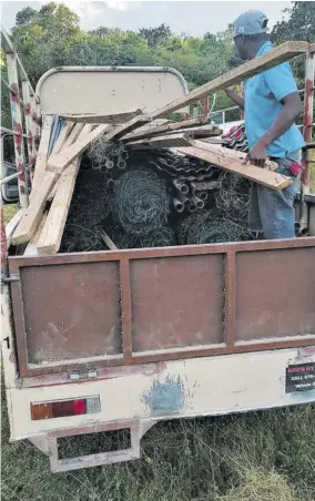  ?? ?? A workman loads items being moved from the Montego Bay Animal Haven’s former location in Orange, St James, to its property in New Milns, Hanover.