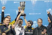  ?? Otto Greule Jr. / Getty Images ?? L.A.’s Robbie Keane hoists the Western Conference championsh­ip hardware in Seattle.