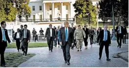  ?? DOUG MILLS/THE NEW YORK TIMES ?? President Trump makes his way to St. John’s church for a photo op Monday. Military leaders ordered active-duty units to clear out peaceful protesters near the White House.