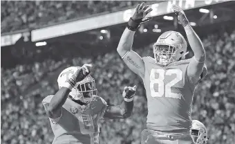  ?? STAFF PHOTO BY C.B. SCHMELTER ?? Tennessee running back John Kelly, left, celebrates his 3-yard touchdown run with tight end Ethan Wolf during the Vols’ homecoming win against Southern Miss on Nov. 4. Kelly and Wolf talked to the Times Free Press about what characteri­stics they would...