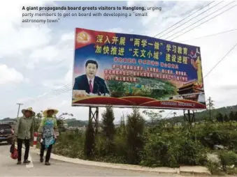  ??  ?? A giant propaganda board greets visitors to Hanglong, urging party members to get on board with developing a “small astronomy town”