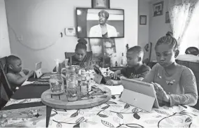  ?? ARIEL COBBERT/THE COMMERCIAL APPEAL ?? Vollentine Elementary School student Cseriah Starks, Sincere Dorse, Alexis Dorse and Major Dorse do their homework after virtual school hours, on Wednesday, March 24, 2021.