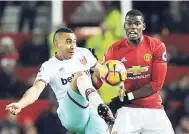  ??  ?? West Ham’s Dimitri Payet (left) and Manchester United’s Paul Pogba during the English Premier League match between Manchester United and West Ham United at Old Trafford in Manchester, England, yesterday. The game ended 1-1.