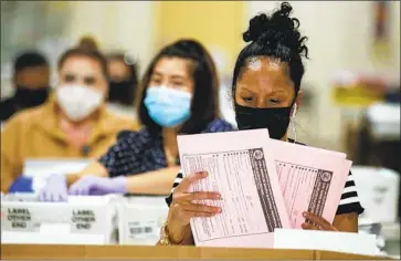 ?? Irfan Khan Los Angeles Times ?? ELECTION WORKER Phyliss Greer sorts ballots at the L.A. County registrar’s office in Pomona on Wednesday. Of the votes counted so far, nearly 64% have been in favor of keeping Gov. Gavin Newsom in office.