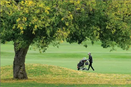  ?? The Daily Courier ?? A golfer makes her way up the 10th fairway at Shannon Lake Golf Club in this file photo. Shannon Lake is one of three courses planning to open this week with physical-distancing rules in place.