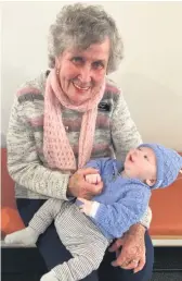  ?? ?? Our eldest volunteer Phyl Watson with one of our new babies Hudson Smith in the woollies knitted for him by L4L.