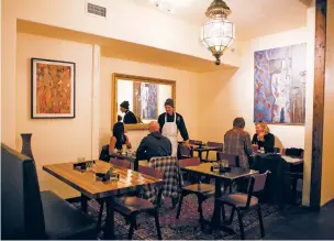  ?? PHOTOS BY OLIVIA HARLOW/THE NEW MEXICAN ?? LEFT: Chef Neema Sadeghi visits with customers in Milad’s new dining room last week. ‘For me and my crowd, it’s perfect,’ Sadeghi said of his restaurant’s new home.