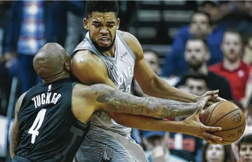  ?? Brett Coomer / Houston Chronicle ?? Rockets forward P.J. Tucker, left, takes a shoulder to his face from Timberwolv­es center Karl-Anthony Towns for his defensive efforts during Game 1.