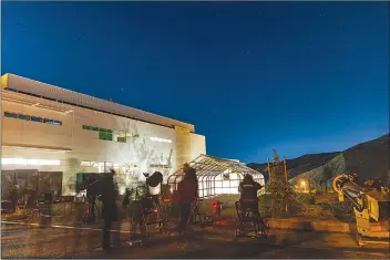  ?? Chris Torres/The Signal ?? Event attendees look through telescopes under the night sky at The College of the Canyons Spring 2022 Star Party at the Canyon Country Campus on Friday.