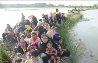  ??  ?? Fleeing Rohingya refugees pause to rest at the Bangladesh-Myanmar border. (AN photo)