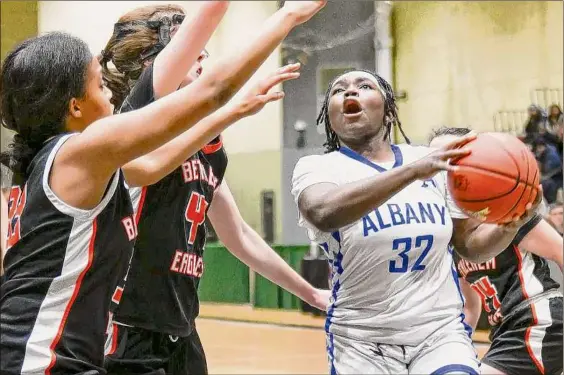  ?? Jim Franco / Times Union ?? Albany sophomore Azera Gates drives to the basket in front of Bethlehem defenders Makaya Mccann, left, and Katherine Bannigan during the Section II Class AA finals on Friday at Hudson Valley Community College in Troy. Gates had 10 points, six assists and five rebounds in the title game.