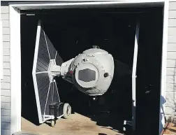  ??  ?? Allan Carver of Queensland, N.S., welded together steel, foam and scrap wheelchair motors to create a two-metre tall remote-controlled replica of the Star Wars Imperial Fleet’s go-to fighter.