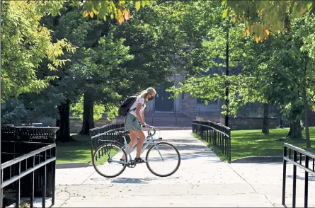  ?? Photos by Matthew Jonas / Staff Photograph­er ?? A person bicycles on a nearly empty campus at the University of Colorado Boulder on Wednesday. Chancellor Phil Distefano announced Wednesday that some in-person classes would resume Oct. 14.