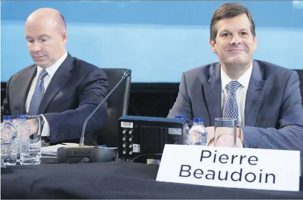  ?? RYAN REMIORZ/THE CANADIAN PRESS ?? Bombardier CEO Alain Bellemare, left, and chairman Pierre Beaudoin open the company’s annual meeting Thursday. Beaudoin’s compensati­on will be adjusted due to his new non-executive role on the board after losing support from major pension funds.