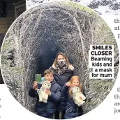  ??  ?? SMILES CLOSER Beaming kids and a mask for mum