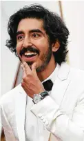  ?? Valerie Macon / AFP | Getty Images ?? Dev Patel wears a dapper white Burberry tux.