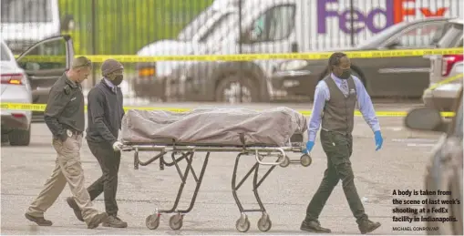  ?? MICHAEL CONROY/AP ?? A body is taken from the scene of last week’s shooting at a FedEx facility in Indianapol­is.