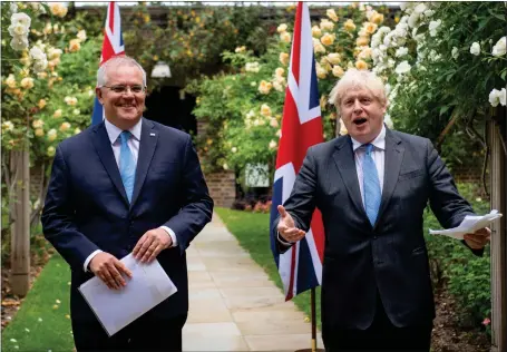  ??  ?? Boris Johnson, right, and Australian PM Scott Morrison in the garden of 10 Downing Street, after agreeing the broad terms of a free trade deal