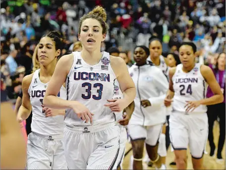  ?? SEAN D. ELLIOT/THE DAY ?? UConn players jog off the court after losing to Notre Dame 91-89 in overtime in NCAA Final Four national semifinals on Friday night at the Nationwide Arena in Columbus, Ohio.