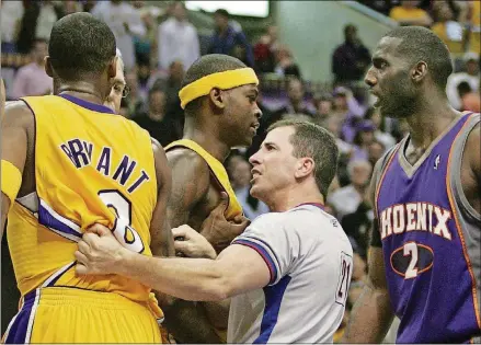  ?? JEFF LEWIS/AP ?? NBA official Tim Donaghy separates Phoenix Suns and Los Angeles Lakers players during the second half of the Lakers’ 99-92 victory in an NBA basketball first-round playoff game in this April 28, 2006, file photo, in Los Angeles.