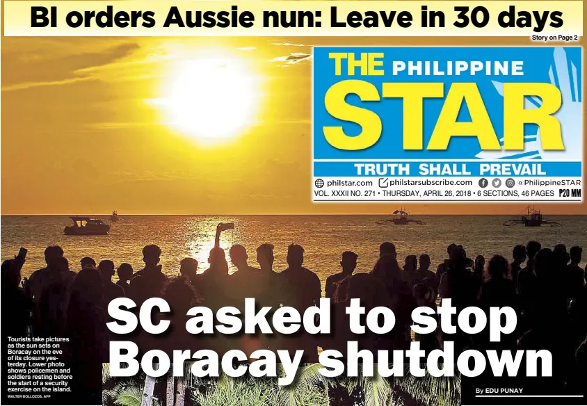  ?? WALTER BOLLOZOS, AFP ?? Tourists take pictures as the sun sets on Boracay on the eve of its closure yesterday. Lower photo shows policemen and soldiers resting before the start of a security exercise on the island.