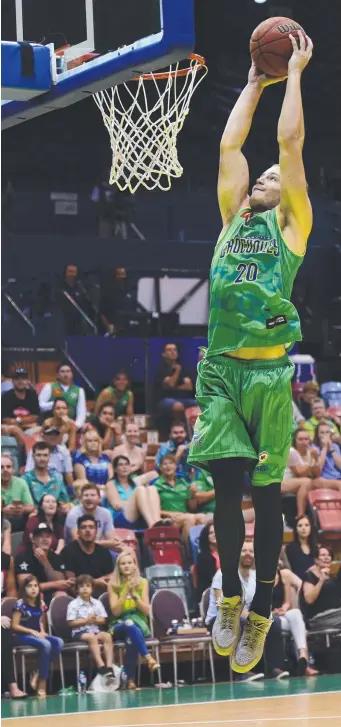  ?? Main picture: WESLEY MONTS ?? Man for all seasons Tom Howard prepares to dunk for the Townsville Crocodiles in the NBL and (inset left) playing Aussie rules for Surfers Paradise.