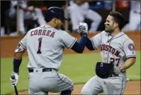  ?? The Associated Press ?? ROCKET MEN: Houston teammates Carlos Correa, Jose Altuve and George Springer could be in the American League’s starting lineup when All-Star rosters are announced Sunday night. Correa (1) and Altuve are pictured congratula­ting Alteve’s home run against...