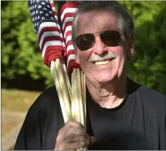  ?? PETE BANNAN - MEDIANEWS GROUP ?? Detachment Commandant Jim Cook gets ready to place flags at Arlington Cemetery.