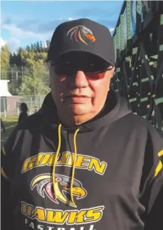  ?? CITIZEN PHOTO BY TED CLARKE ?? Albert McNab, coach of the Regina Golden Hawks, watches his team warm up before their game againd Big Guy Lake Saturday night at the Canada Day Fastpitch Tournament at Spruce City Stadium.