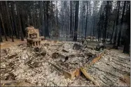  ?? AP PHOTO/ETHAN SWOPE ?? The remnants of a foundation is all this left after a property was destroyed by the Caldor Fire in Grizzly Flats, Calif., on Tuesday, Aug. 17, 2021.