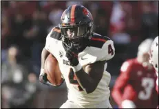  ?? Associated Press ?? Oregon State running back B.J. Baylor carries the ball during the second half against Washington State on Oct. 9 in Pullman, Wash. Baylor has four straight 100-yard games and 10 touchdowns this season.