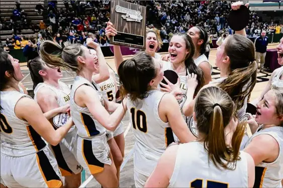  ?? Jim Franco / Times Union ?? Averill Park junior Taylor Holohan hoists the Section II Class A championsh­ip plaque after the Warriors defeated Catholic Central on Friday at Hudson Valley Community College in Troy. The title was the school’s ninth consecutiv­e Class A sectional title, and 14th since 2006.