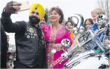  ??  ?? Left: NDP Leader John Horgan arrives at a Vaisakhi event at the Khalsa Diwan Society Sikh Temple in Vancouver on Saturday. Right: Liberal Leader Christy Clark poses for a selfie with a member of a Sikh motorcycle club.