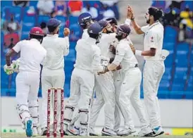  ?? AP PHOTO ?? Indians celebrate a West Indies dismissal on the fourth day of the first Test on Sunday.