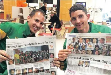  ??  ?? POSTER BOYS: Paralympia­ns Arnu Fourie and Hendrik Herbst share a proud moment after being featured in the Cape Times before setting off for the Paralympic­s in Rio.