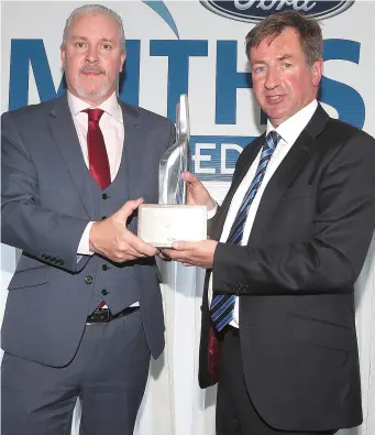  ??  ?? Nicky Smith receives prestigiou­s Ford Chairman’s Award for excellence in Customer Service from Ciarán McMahon MD Ford Motor Company