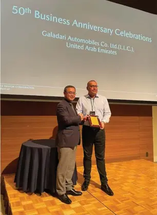  ?? ?? Axel Dreyer (right) receives the award from Mazda’s Aoyama San to mark 50 years of the Galadari-mazda partnershi­p.