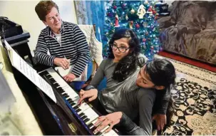  ??  ?? They play the piano using Carmen’s right hand and Lupita’s left; the twins have been taking lessons, at their mother’s insistence, for about eight years.