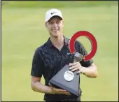  ?? Associated Press ?? ON TOP
Cam Davis of Australia holds the winner’s trophy after the final round of the Rocket Mortgage Classic on Sunday at the Detroit Golf Club in Detroit. Davis won on the fifth playoff hole.