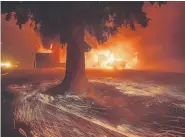  ?? Noah Berger, The Associated Press ?? Flames consume a Kentucky Fried Chicken restaurant as the deadly Camp fire tears through Paradise, Calif., on Thursday.